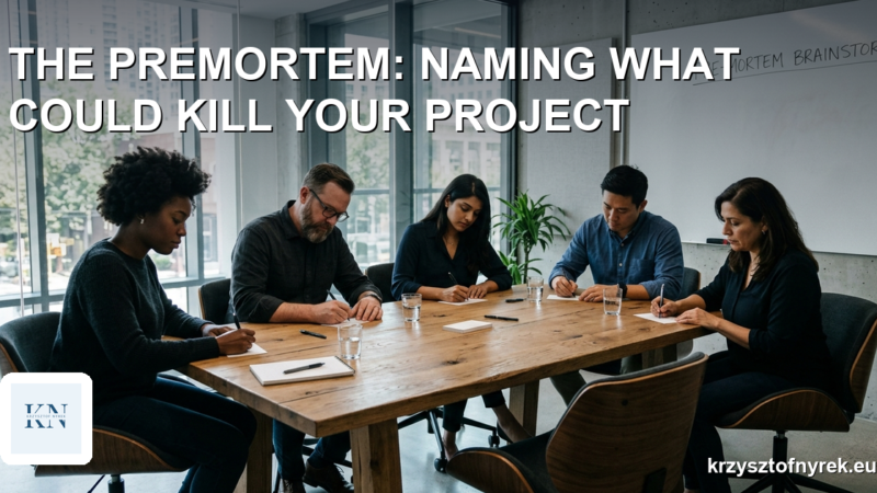 Five colleagues sit around a table silently writing on index cards during a premortem exercise
