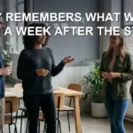 A project team at a morning standup in an office, one person speaking while others listen