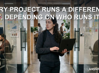 Developer with a laptop standing between two project team rooms