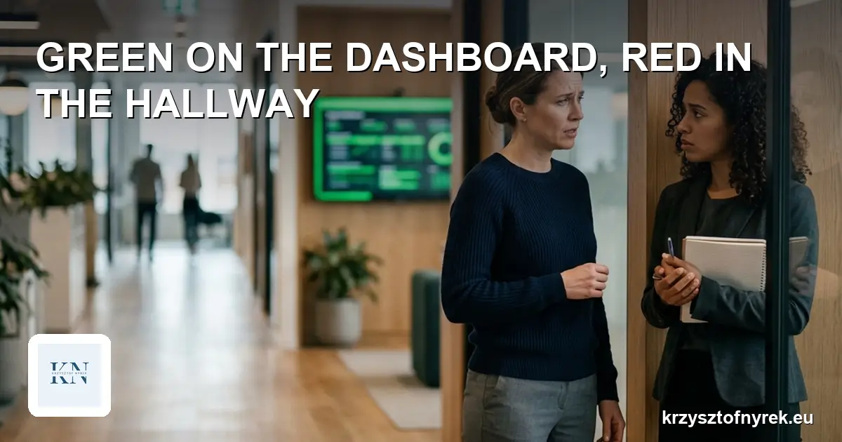 Two colleagues talking in an office hallway with a green project dashboard in the background